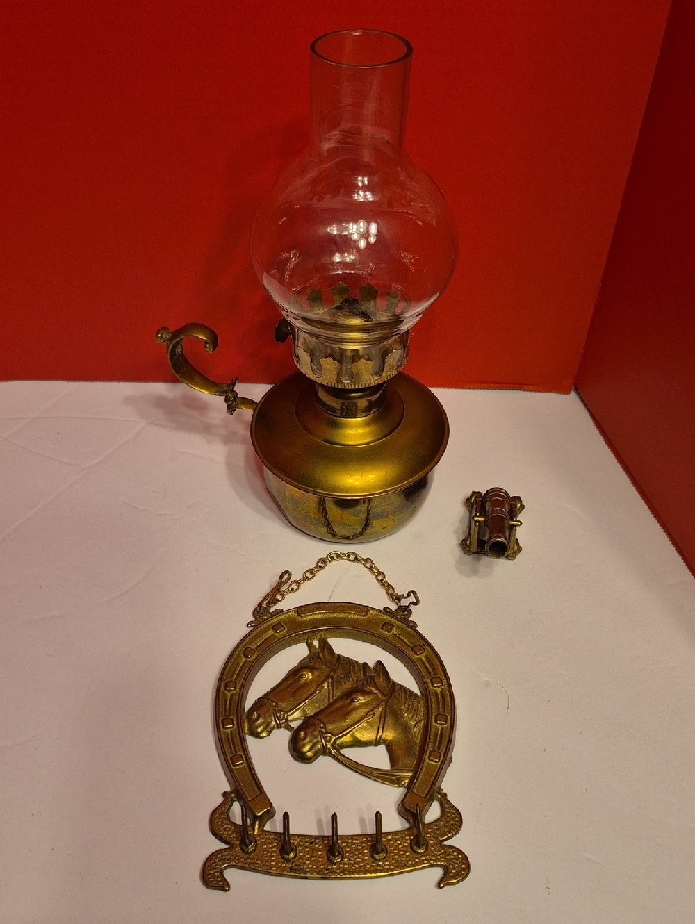 Vintage Brass Finish Oil Lamp, Brass Canon and Decorative Horse Hook